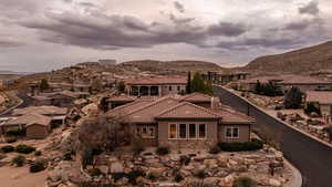 View of front of house featuring a residential view, a mountain view, stucco siding, and stone siding