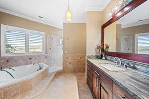 Full bath featuring vanity, ornamental molding, walk in shower, a bath, and light tile patterned flooring
