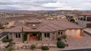 Mediterranean / spanish home featuring stone siding and a mountain view