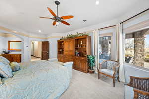 Bedroom with light colored carpet, a ceiling fan, and recessed lighting