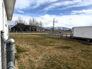 View of yard with a gate and a mountain view