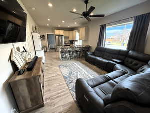 Living room featuring recessed lighting, light wood-style flooring, and ceiling fan