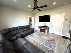 Living area with recessed lighting, light wood-style floors, and ceiling fan
