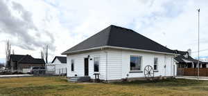 Side of property with a shingled roof