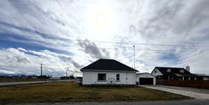 Bungalow-style home with an outdoor structure and a garage