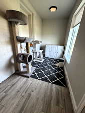 Entry space featuring wood finished floors and baseboards