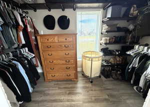 Walk in closet featuring light wood-type flooring