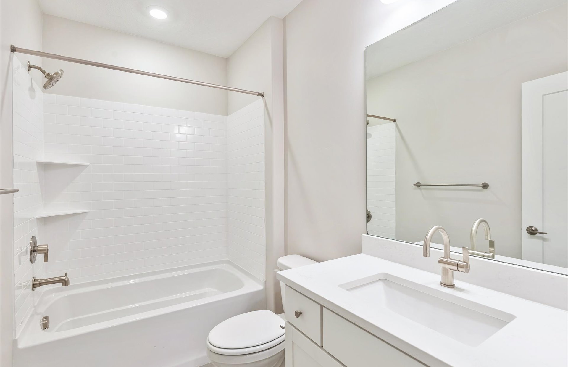 Bathroom with vanity, shower / washtub combination, and recessed lighting