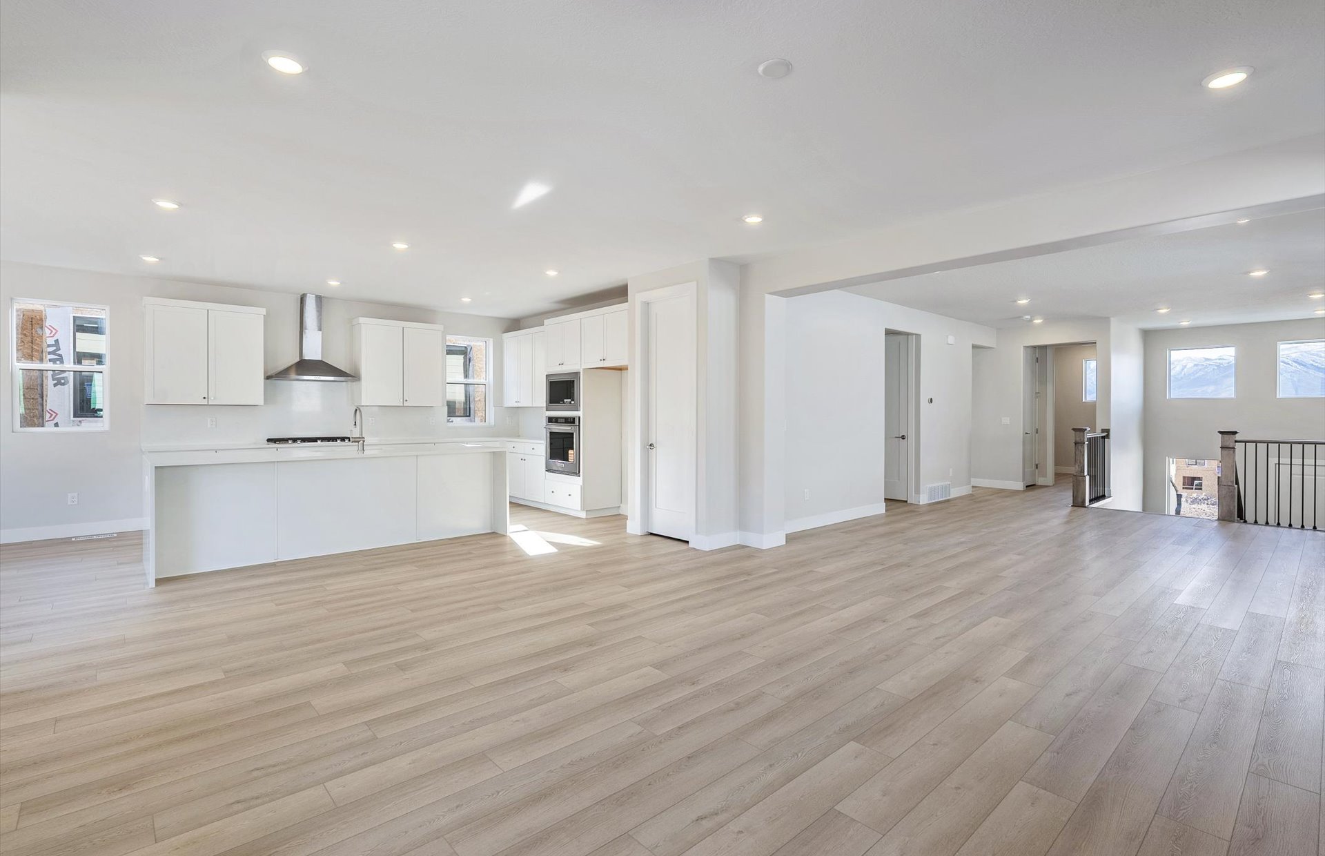 Unfurnished living room featuring light wood-type flooring and recessed lighting
