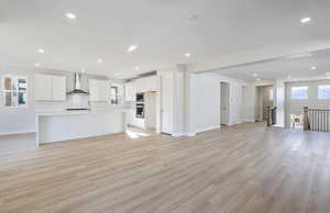 Unfurnished living room featuring light wood-type flooring and recessed lighting