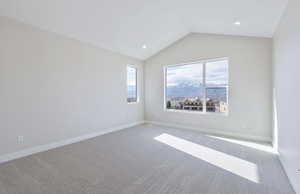 Carpeted empty room featuring recessed lighting and a mountain view