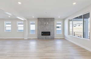 Gathering Room with a fireplace and light wood-type flooring