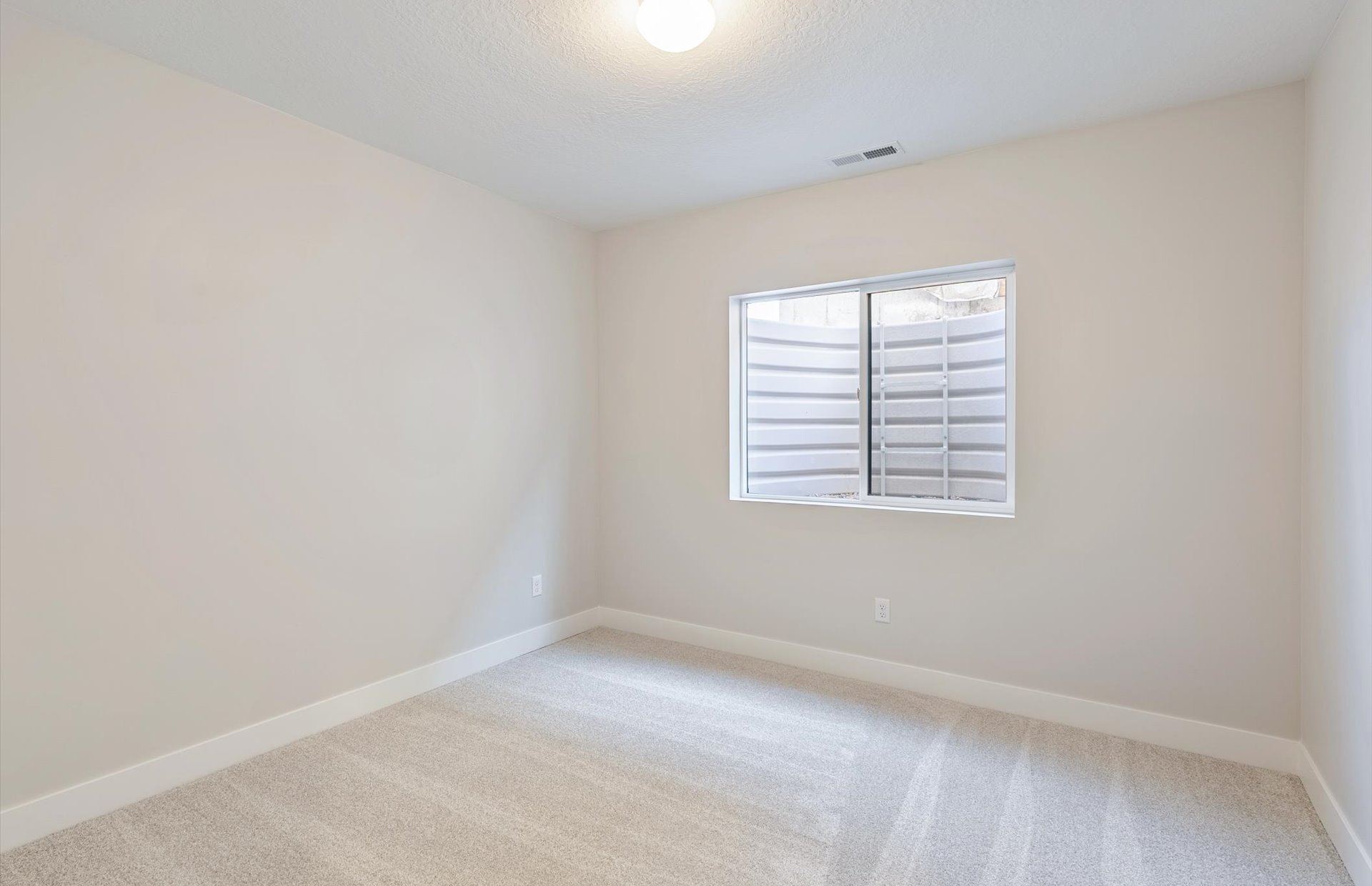 Unfurnished room featuring carpet and baseboards