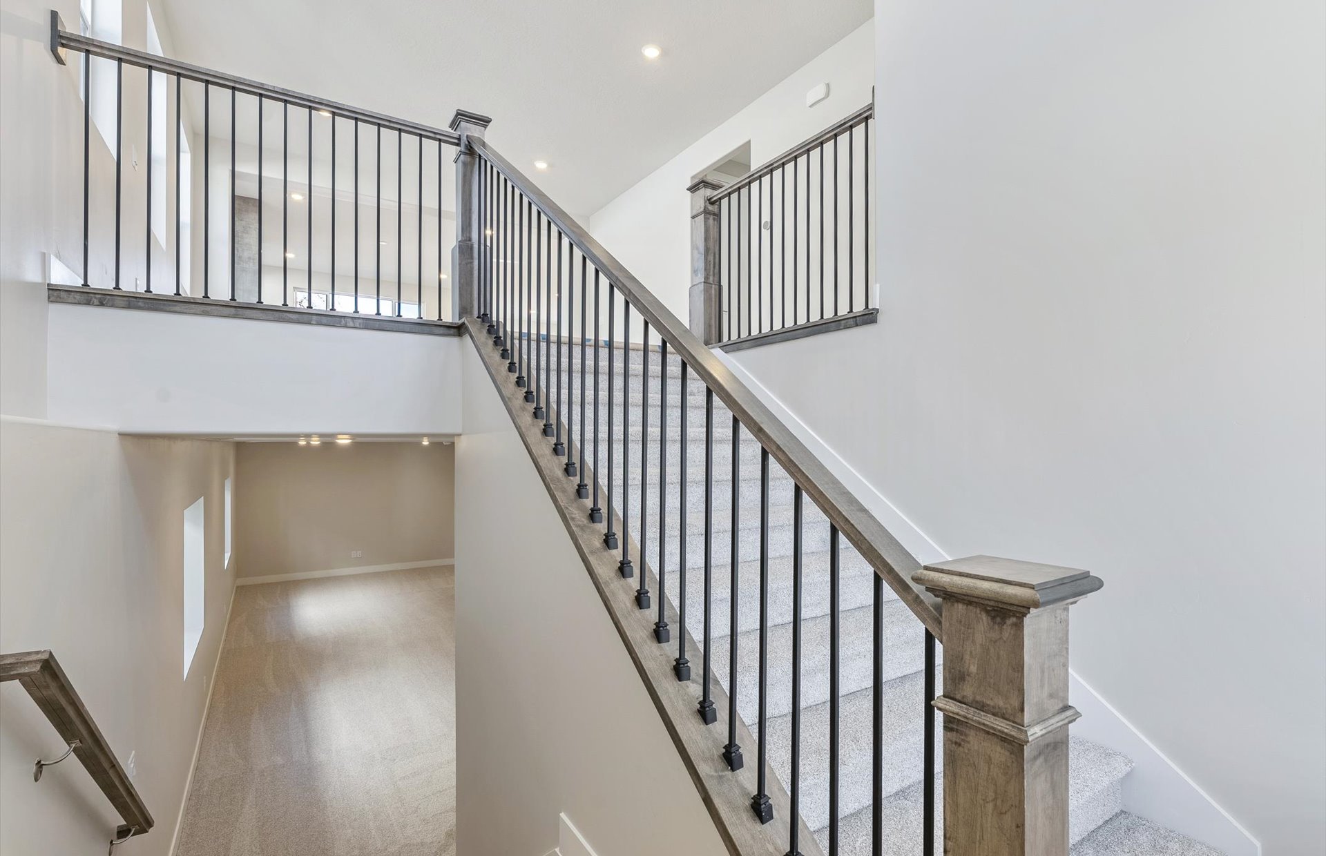 Staircase with a high ceiling, carpet flooring, and recessed lighting