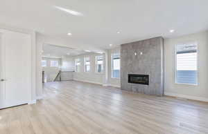 Flex room and Gathering Room featuring a tile fireplace