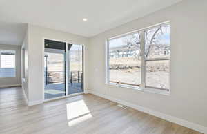 Unfurnished dining area with light wood-style floors, healthy amount of natural light, and recessed lighting