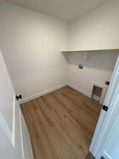 Laundry room featuring dark wood-style floors and hookup for a washing machine