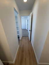Hall featuring baseboards and light wood-style floors