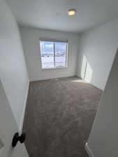 Unfurnished room featuring baseboards and carpet flooring