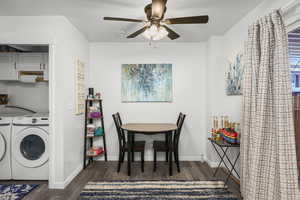 Laundry room featuring dark wood finished floors, ceiling fan, cabinet space, and separate washer and dryer