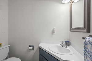 Half bath featuring vanity and toilet