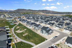 Aerial view of property's location featuring mountains and nearby suburban area