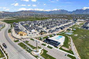 Aerial view of residential area featuring a mountain backdrop and a pool area