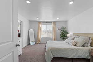Bedroom featuring carpet floors and baseboards
