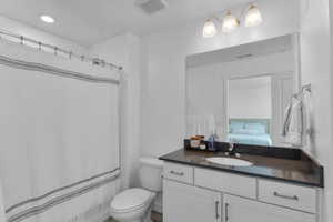 Bathroom featuring ensuite bathroom, vanity, and a shower with shower curtain