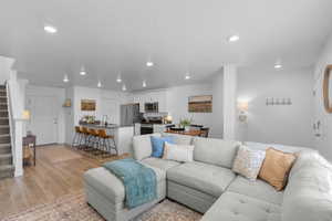 Living area featuring light wood finished floors and recessed lighting