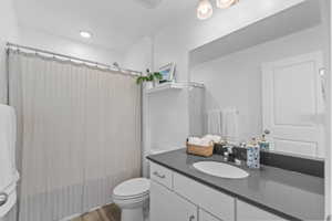 Full bathroom featuring vanity, light wood finished floors, and shower / bath combo
