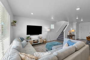 Living area featuring wood finished floors and recessed lighting