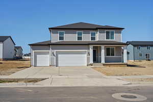 **DISCLAIMER** Elevation & exterior color may vary. View of front of home featuring a porch, driveway, a shingled roof, and a garage