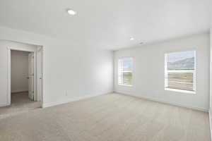 Unfurnished room featuring light carpet and recessed lighting