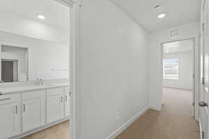 Hallway featuring recessed lighting and light colored carpet