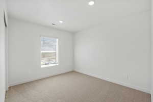 Unfurnished room featuring light carpet and recessed lighting