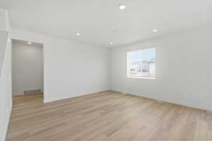 Unfurnished room with light wood-style floors and recessed lighting