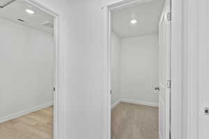 Hallway featuring recessed lighting, elevator, and light wood finished floors
