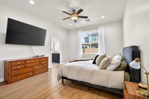 Primary Bedroom with ensuite bath, light wood finished floors, a ceiling fan, and recessed lighting