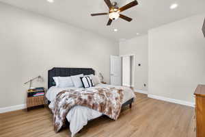 Primary Bedroom with ensuite bath, light wood finished floors, a ceiling fan, and recessed lighting
