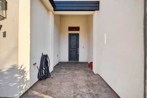 Entrance to property featuring stucco siding
