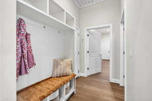 Mudroom featuring light wood-style floors and baseboards