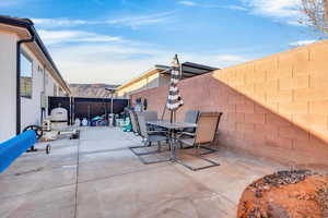 Fenced backyard with a patio and outdoor dining area