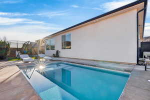 Swimming pool featuring a patio area and a trampoline