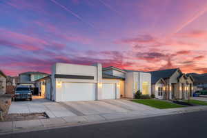 Contemporary house with a 3-car garage, private entrance casita, RV or extra car/toy parking, concrete driveway, and stone siding