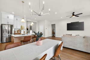Dining space with light wood-type flooring, a ceiling fan, and recessed lighting