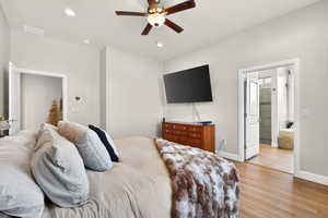 Primary Bedroom with ensuite bath, light wood finished floors, a ceiling fan, and recessed lighting