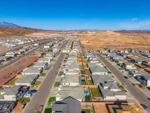 Aerial view of residential area featuring a mountain backdrop and backyard with pool area
