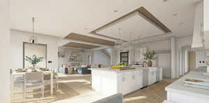 Kitchen featuring white cabinetry, finished concrete floors, a kitchen island with sink, decorative light fixtures, and open floor plan