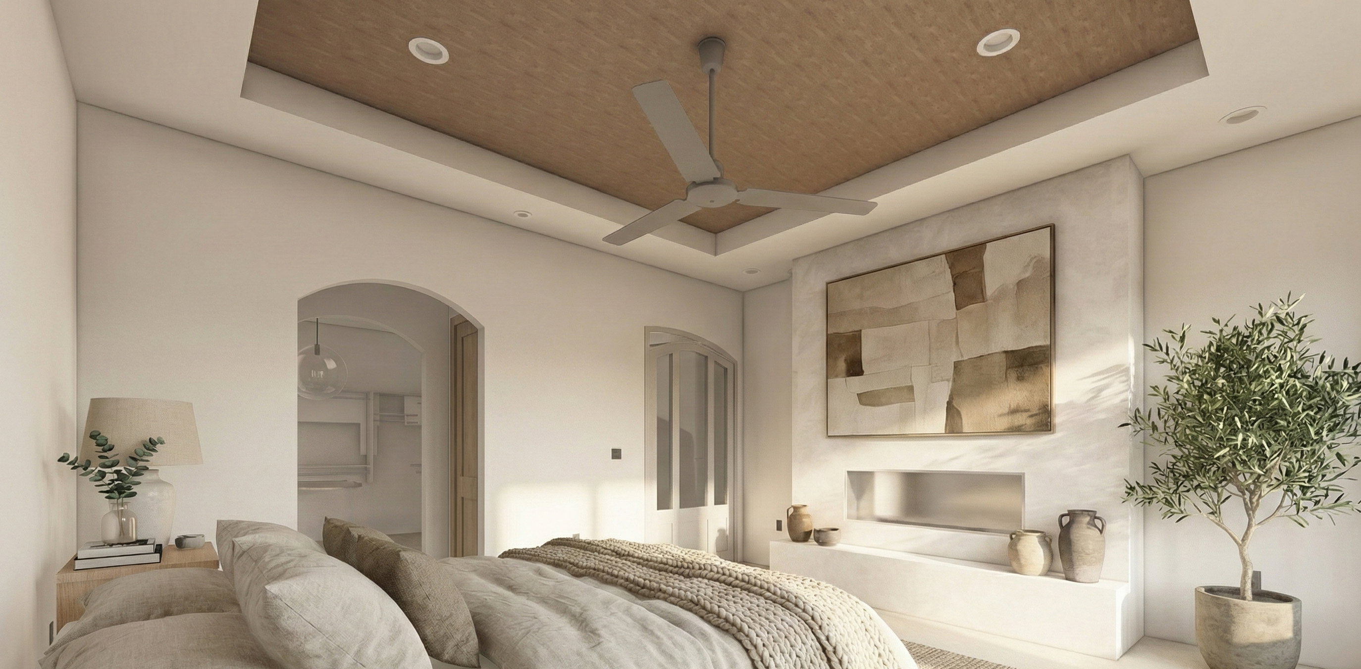 Bedroom featuring a tray ceiling, arched walkways, recessed lighting, and a walk in closet